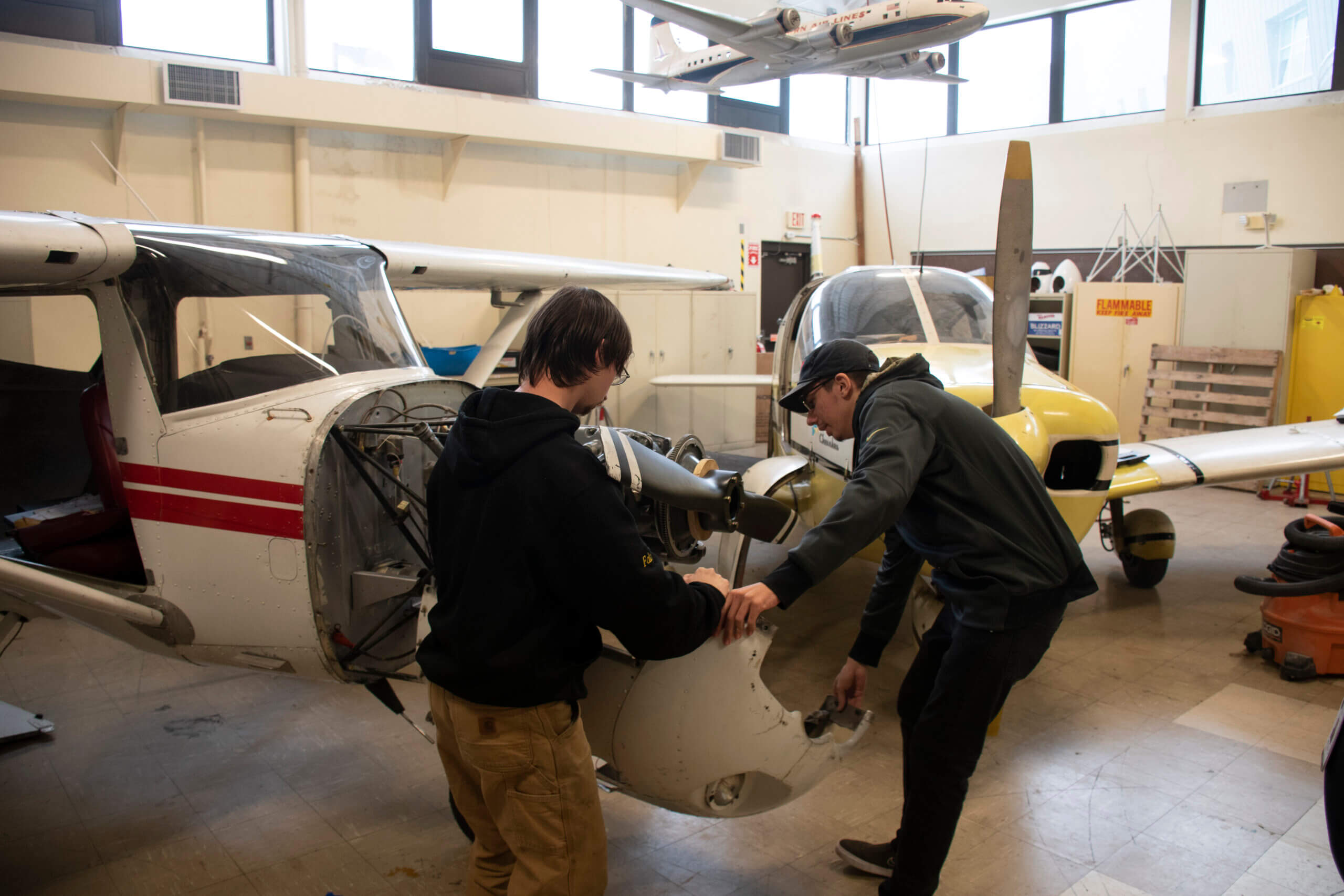 Two students work on an aircraft in the Aviation Lab at NCC