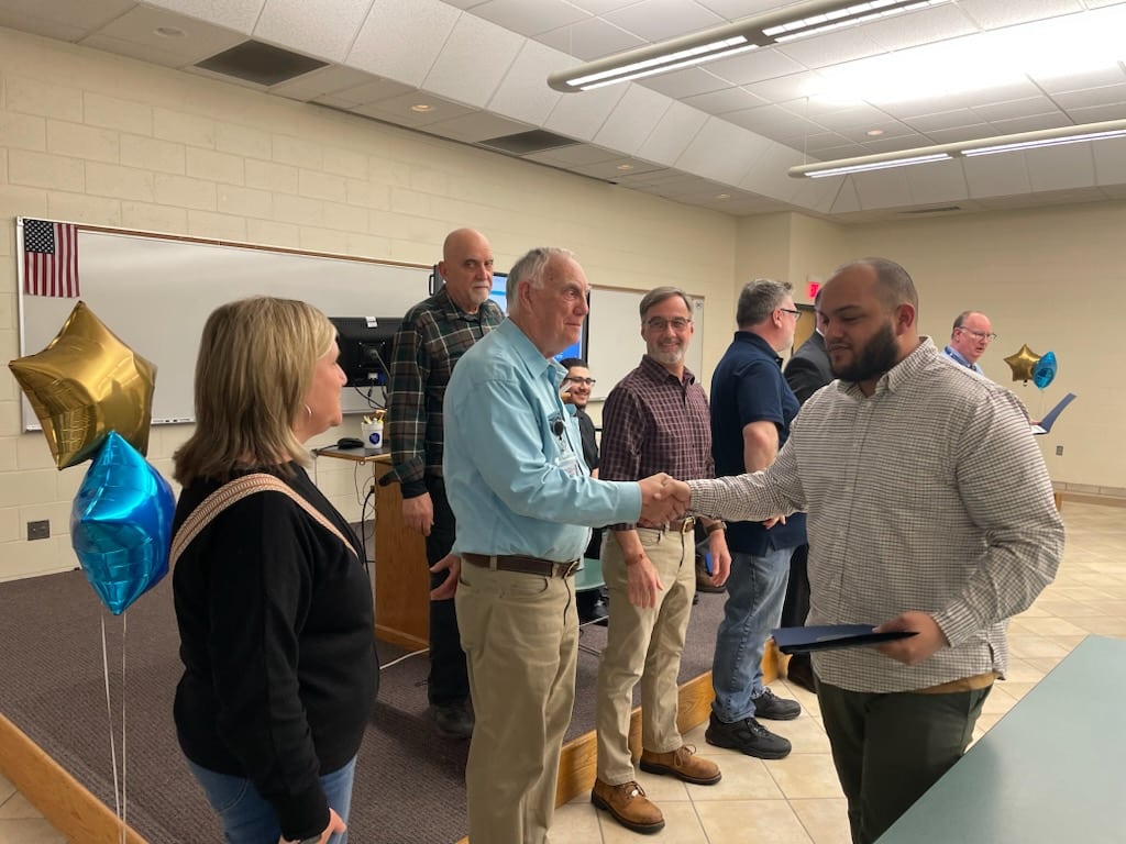 Students receive their certificates during the Precision Manufacturing Boot Camp graduation April 10 at Nashua Community College.